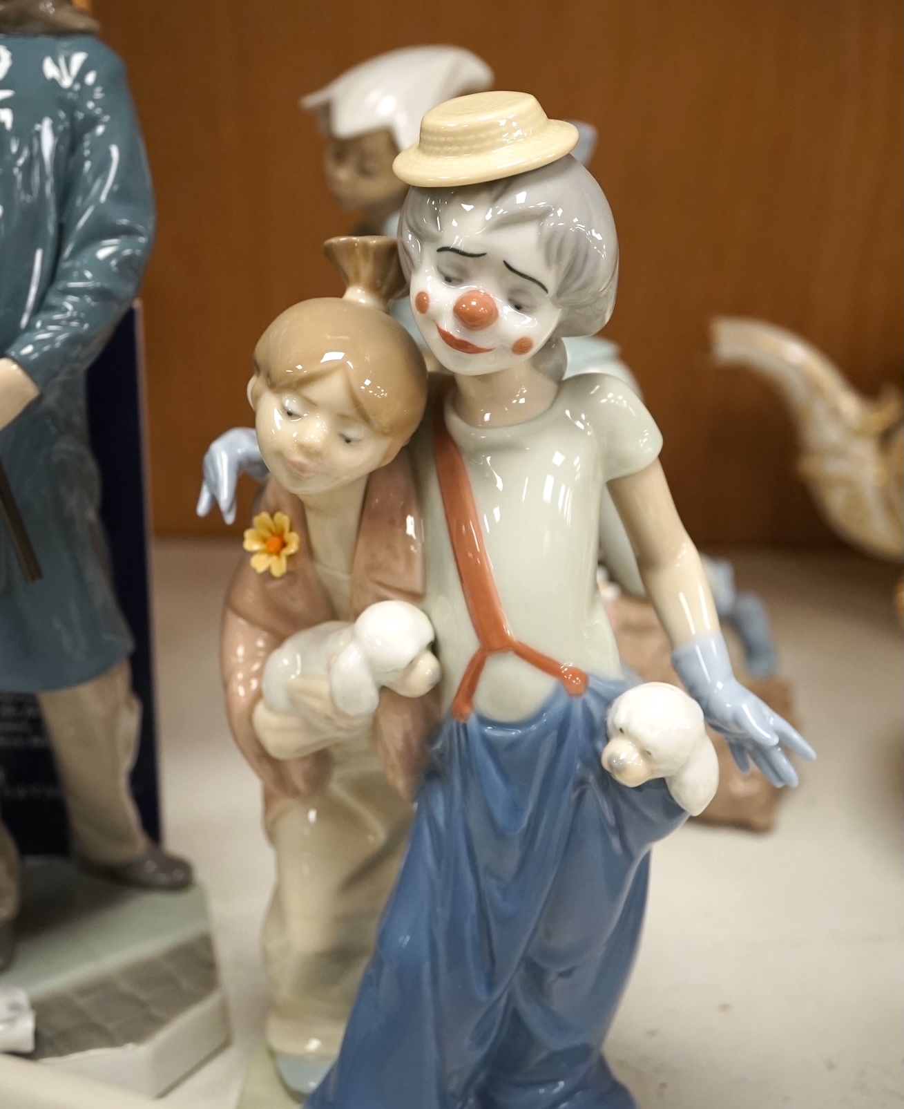 A group of Lladro figures to include ‘Lamplighter’ and ‘All aboard’, largest 48cm high. Condition - good